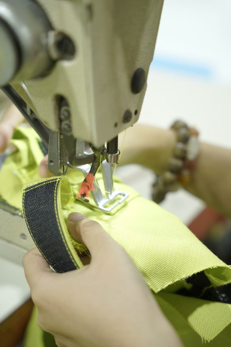 A Viking Vietnam operator working on a technical detail of a protective garment, an operation that requires high precision