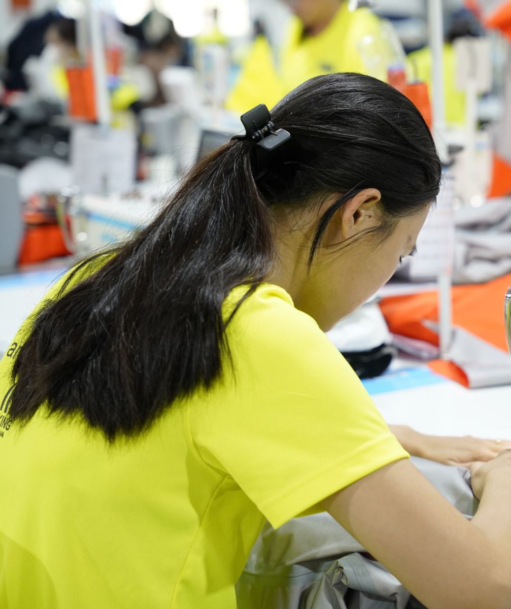 A Viking Vietnam operator performing a sewing operation on a technical product, where a small defect can begin and where it can be caught earliest