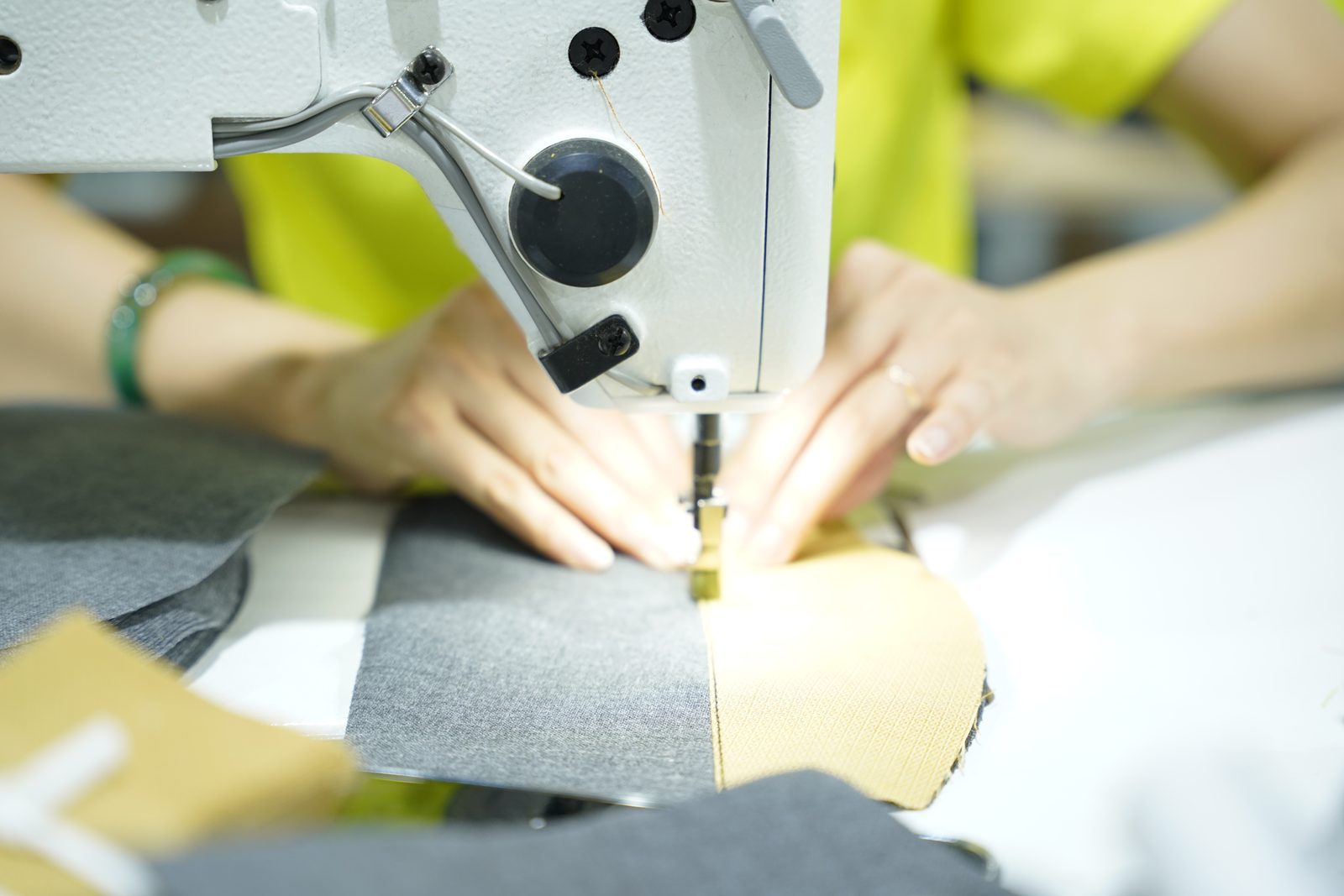 A Viking Vietnam operator positioning a detail with both hands before feeding it into the machine