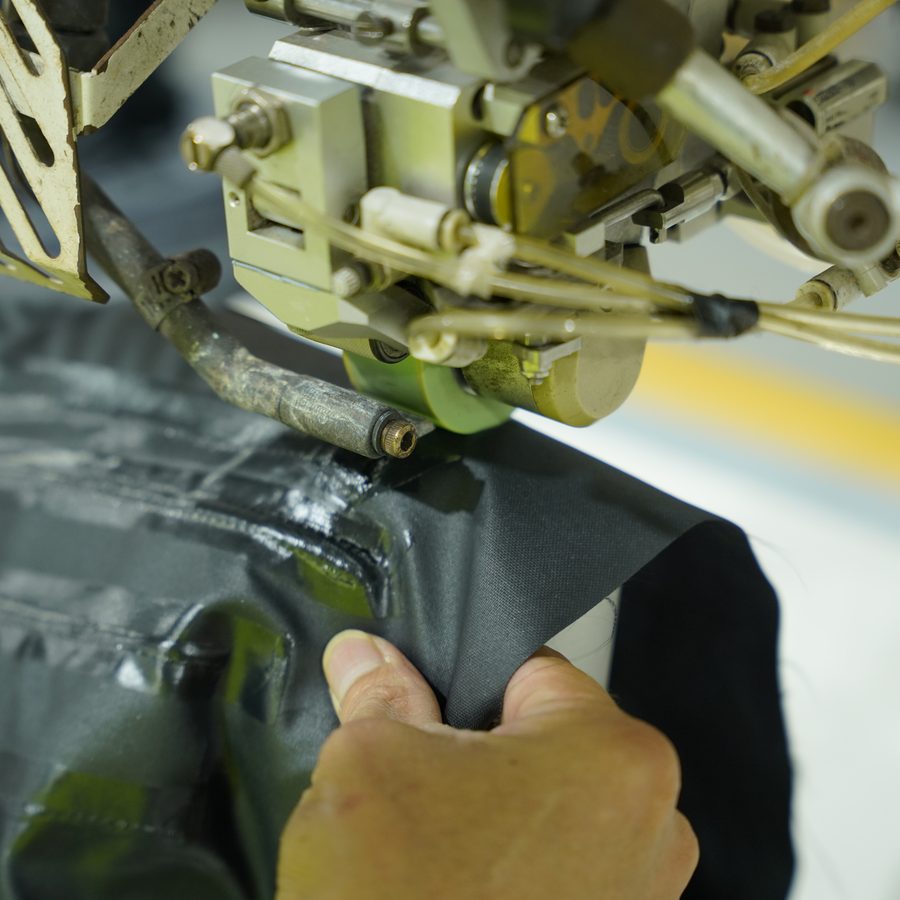 A seam sealing machine at Viking Vietnam applying tape over the seam of a waterproof garment