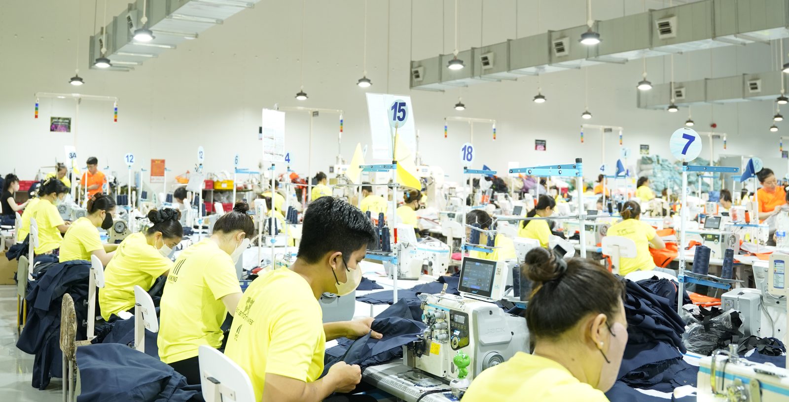 A wide view of the Viking Vietnam sewing floor with numbered station signs and clear material flow
