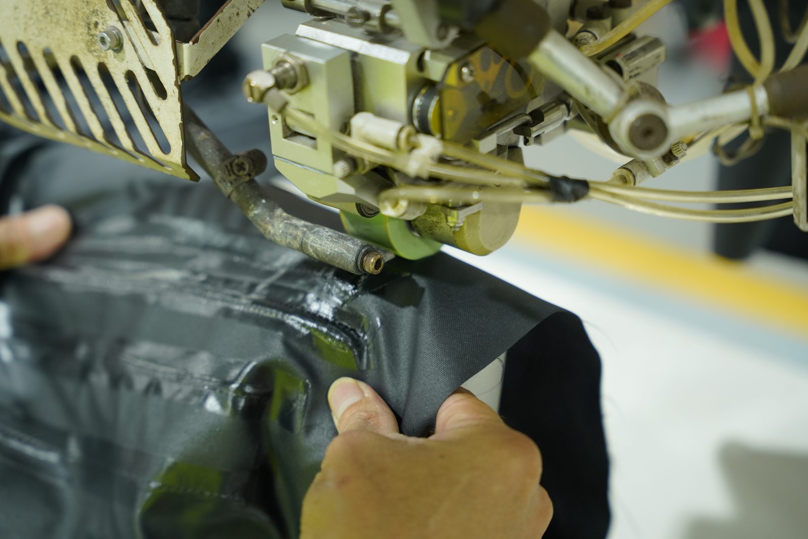 Technical material being processed on a seam taping machine at Viking Vietnam