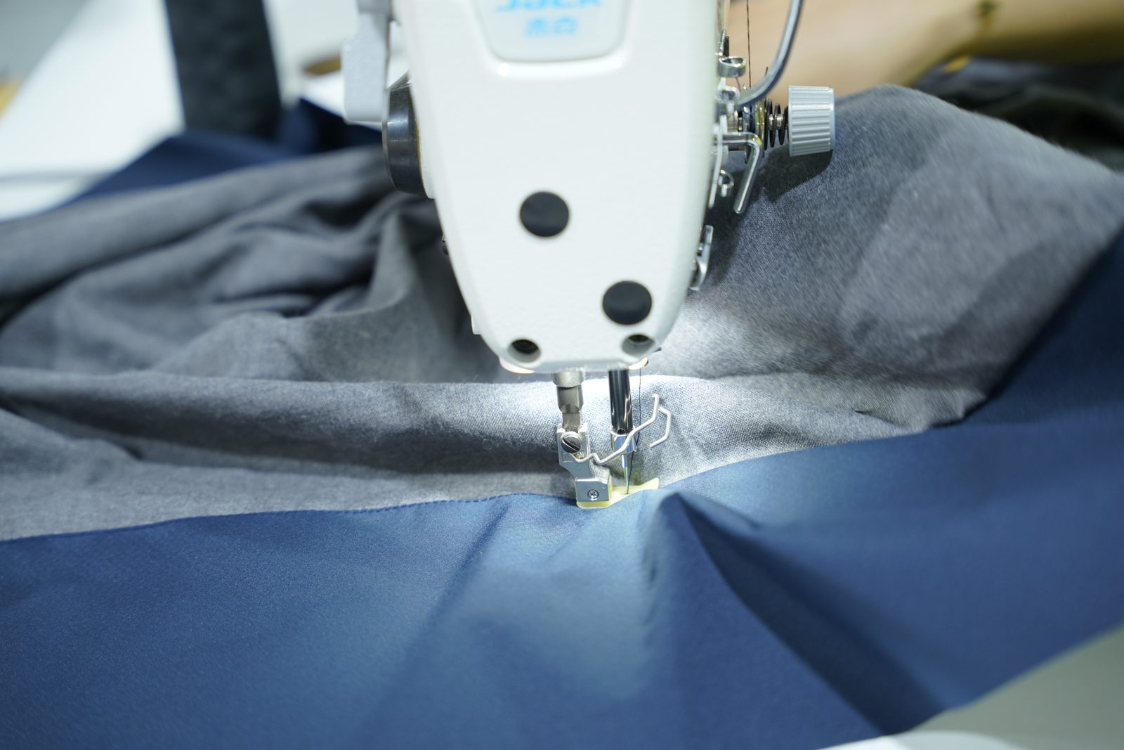 A Viking Vietnam operator performing a sewing operation on a technical product, where correct handling directly affects how the product performs