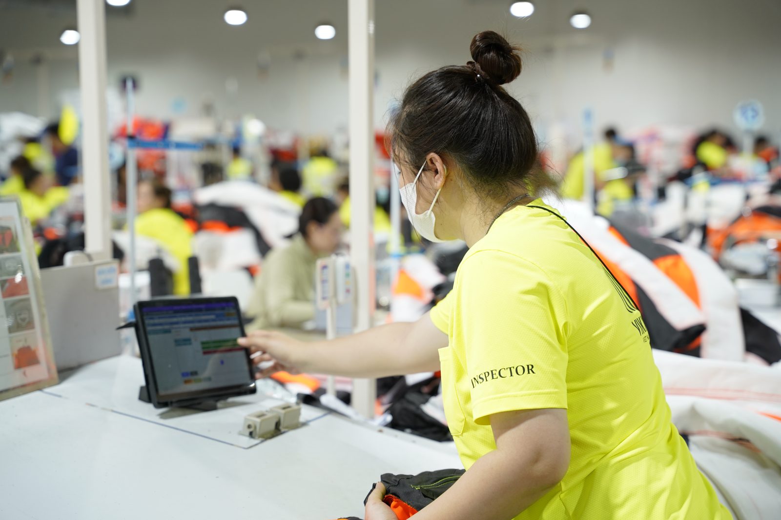 An inspector recording finished garment inspection results at Viking Vietnam