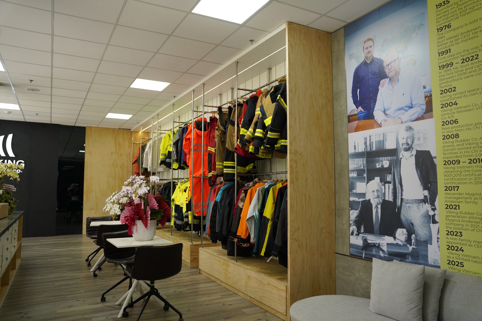 The product display area and company timeline at Viking Vietnam, showing workwear, rainwear and protective clothing lines