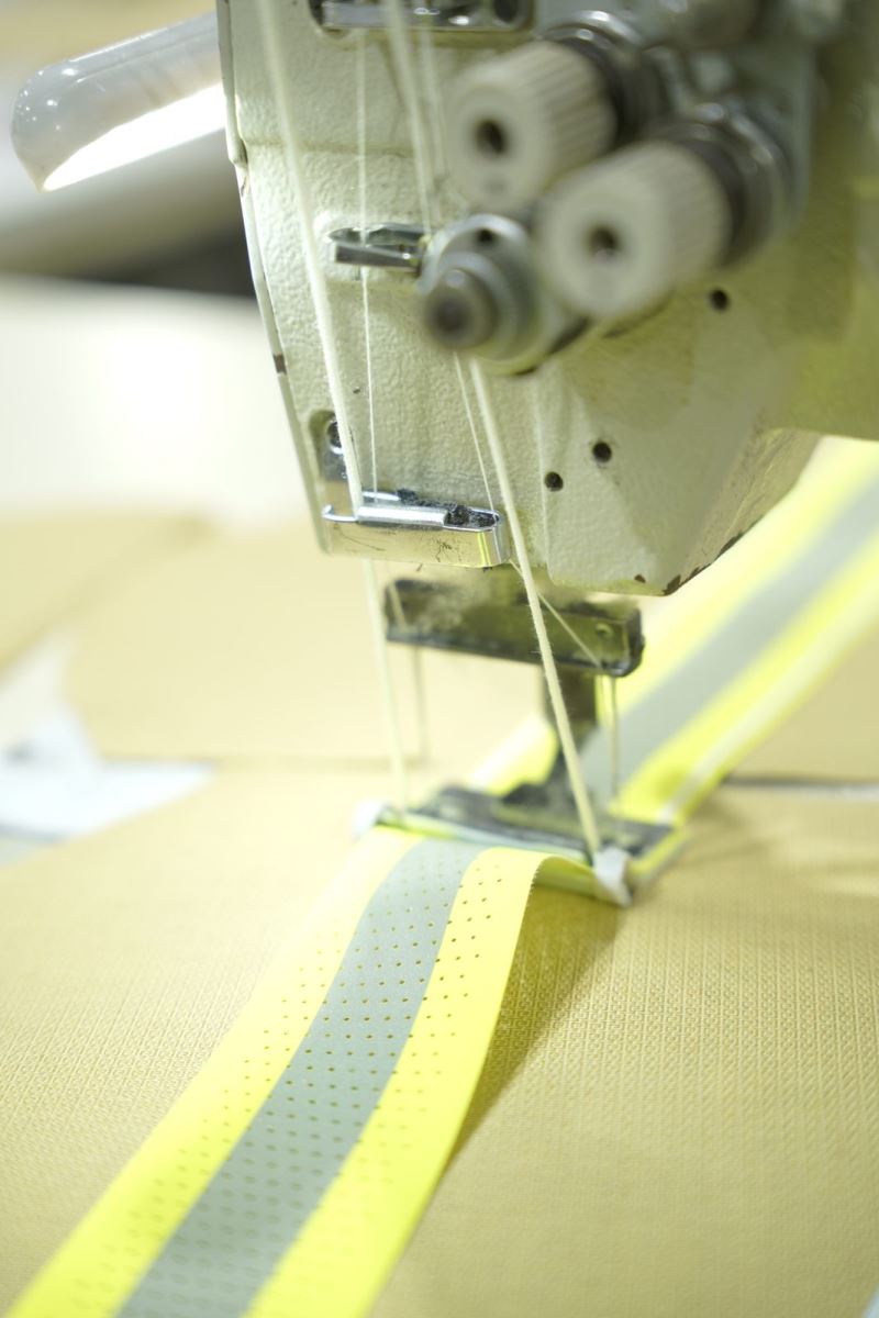Reflective detail being sewn onto technical fabric at Viking Vietnam
