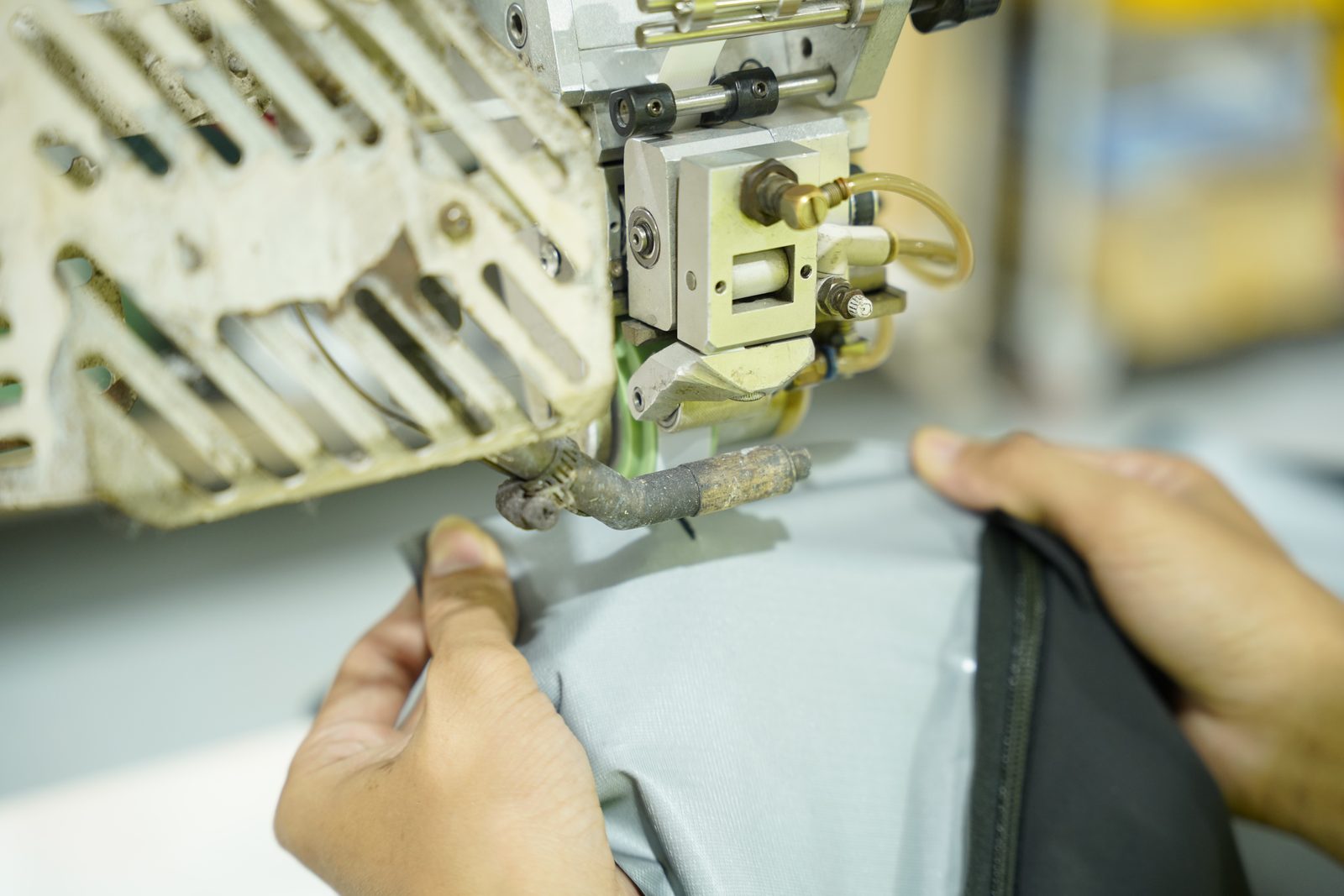 A seam sealing machine at Viking Vietnam being adjusted to suit the material before production