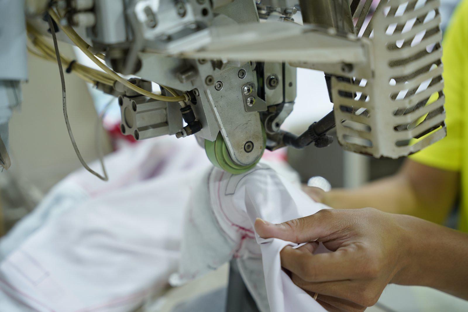 A Viking Vietnam operator sewing along a technical marking line on a garment panel
