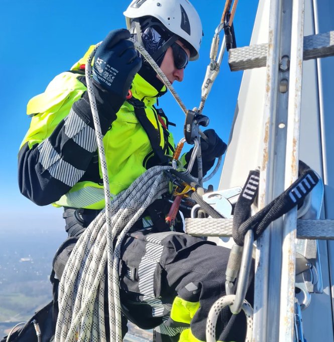 Technician working at height in reflective protective clothing